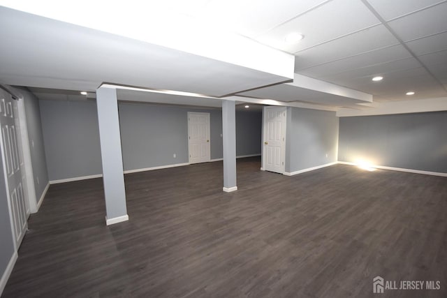 finished below grade area featuring recessed lighting, baseboards, and dark wood-style flooring