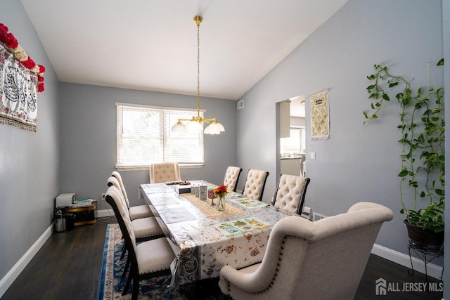 dining space with an inviting chandelier, lofted ceiling, dark wood-style floors, and baseboards