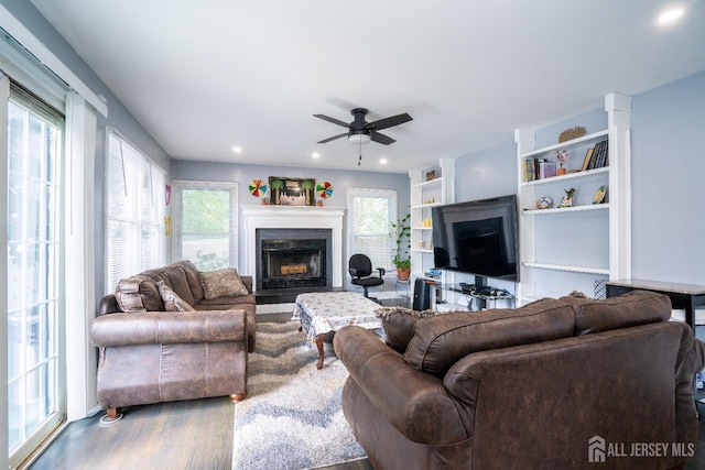 living room with a fireplace with flush hearth, recessed lighting, a ceiling fan, and wood finished floors