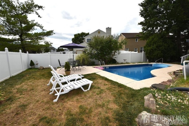 view of pool with a yard, a fenced in pool, a patio, and a fenced backyard