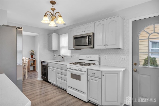 218 Winthrop Ave, Moorestown, NJ 08057 - kitchen with stainless steel appliances, a chandelier, a sink, light countertops, and light wood-style flooring