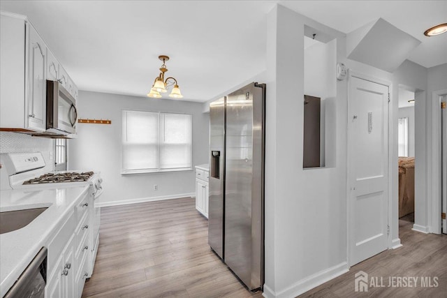 218 Winthrop Ave, Moorestown, NJ 08057 - kitchen with appliances with stainless steel finishes, light wood-style flooring, and white cabinetry