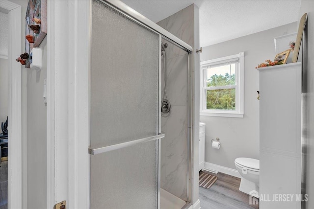 218 Winthrop Ave, Moorestown, NJ 08057 - full bathroom with toilet, a stall shower, wood finished floors, and baseboards