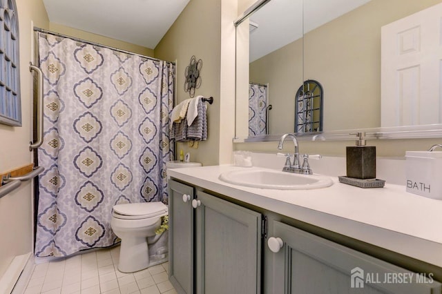 bathroom featuring vanity, tile patterned floors, and toilet