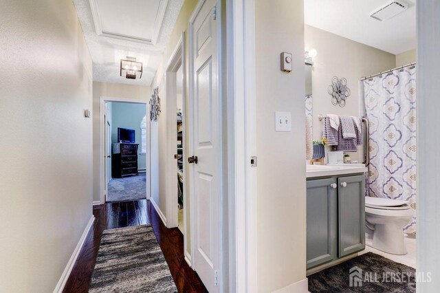 corridor featuring dark wood-type flooring