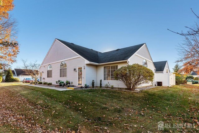 view of property exterior with cooling unit and a lawn