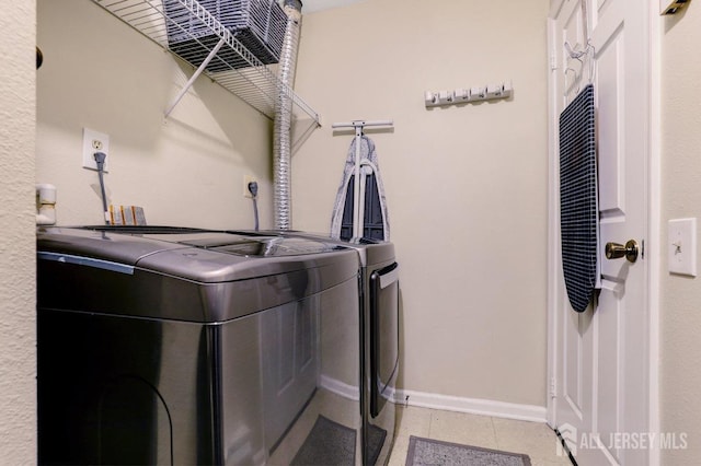 washroom with washing machine and clothes dryer