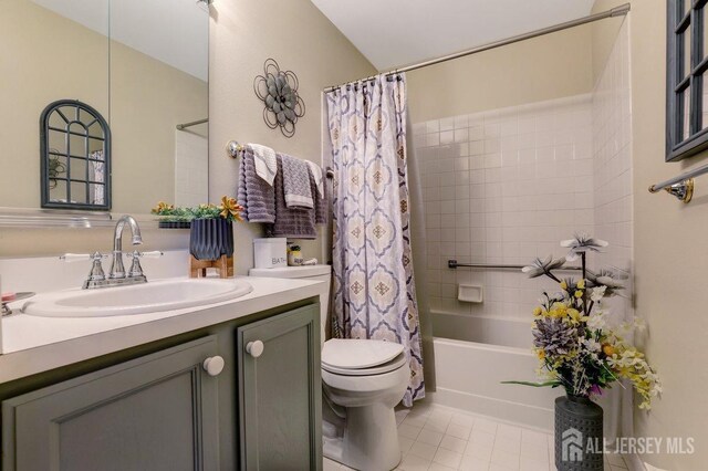 full bathroom with toilet, tile patterned floors, vanity, and shower / bathtub combination with curtain