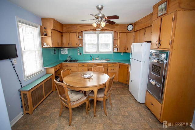 25 S Edward St S, Sayreville, NJ 08872 - kitchen with open shelves, freestanding refrigerator, radiator heating unit, ceiling fan, and stone finish floors