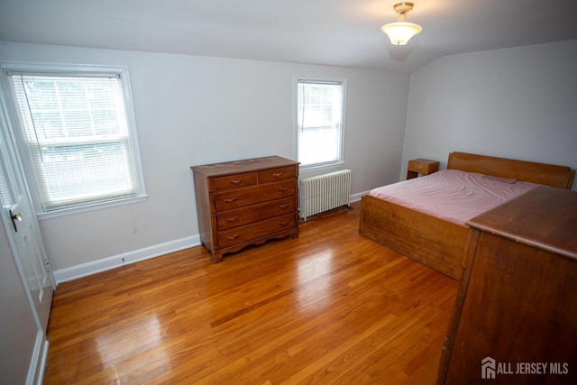25 S Edward St S, Sayreville, NJ 08872 - bedroom with radiator heating unit, light wood-style floors, baseboards, and vaulted ceiling