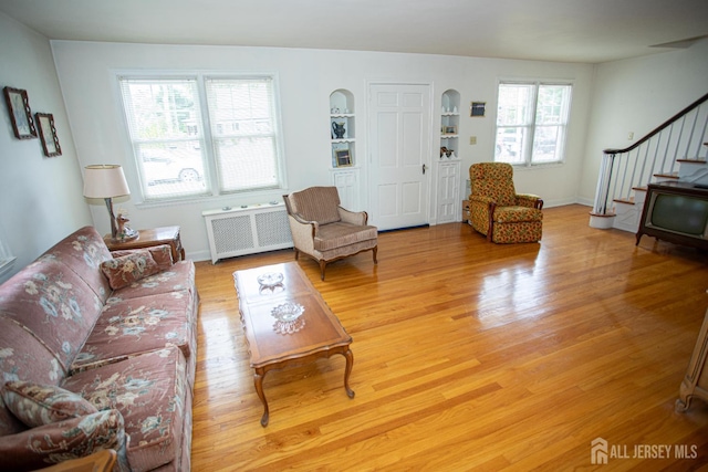 25 S Edward St S, Sayreville, NJ 08872 - living room with radiator heating unit, stairway, light wood-style floors, built in features, and baseboards