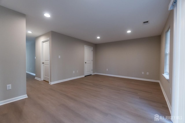 spare room with recessed lighting, baseboards, visible vents, and wood finished floors