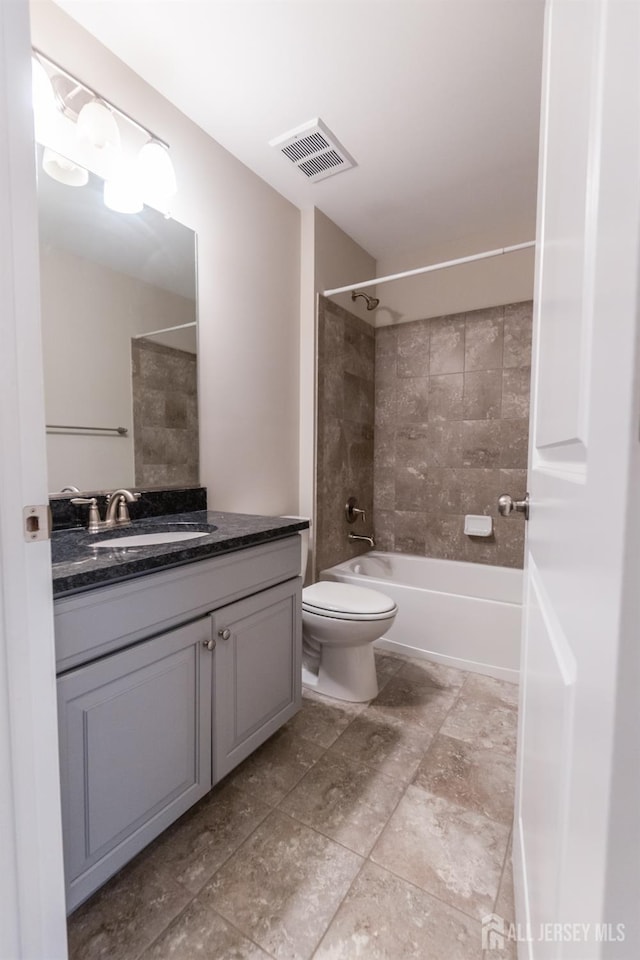 bathroom featuring vanity,  shower combination, visible vents, and toilet