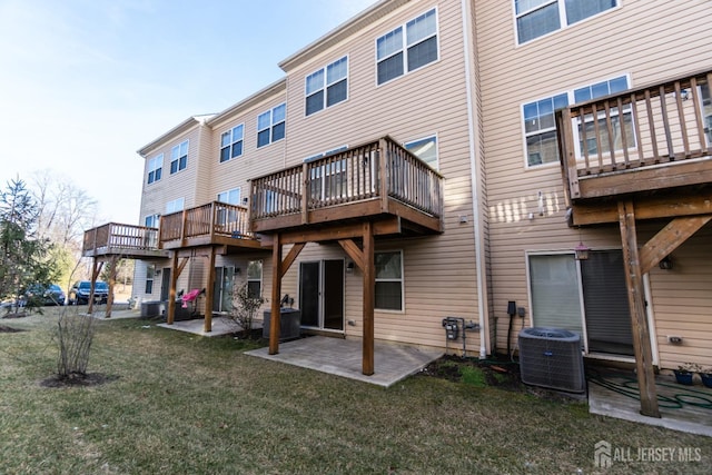 rear view of property with central air condition unit, a patio, and a yard