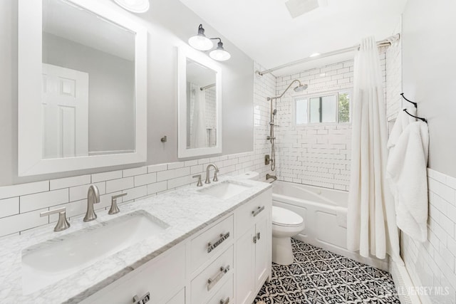 full bathroom with shower / bath combo, tile walls, vanity, and toilet