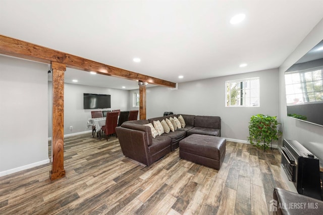 living room with beam ceiling and hardwood / wood-style flooring