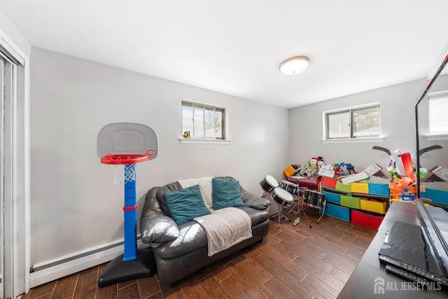 recreation room featuring wood tiled floor and baseboard heating