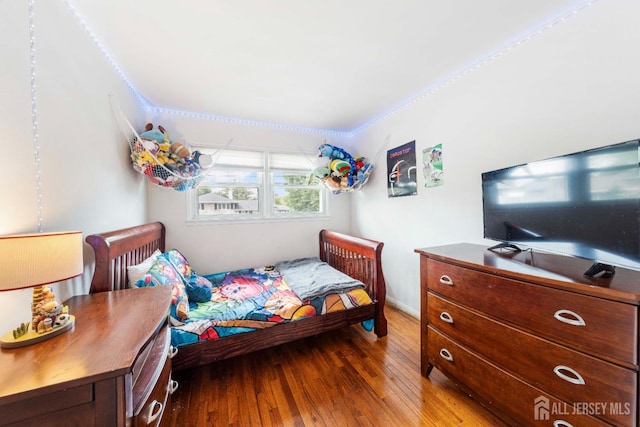 bedroom with wood-type flooring