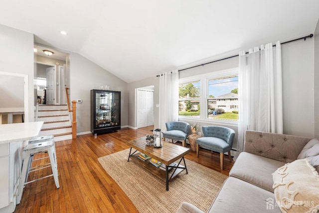 living room with hardwood / wood-style flooring and lofted ceiling