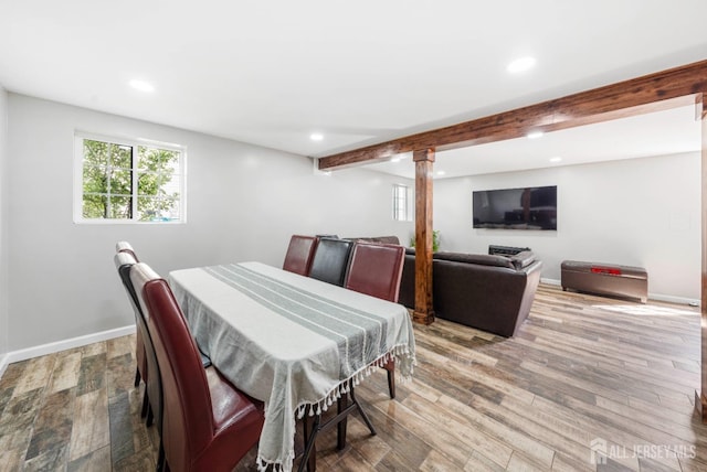 dining room featuring light wood-type flooring, baseboards, beam ceiling, and recessed lighting