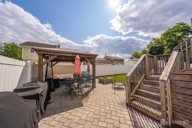 view of patio with a gazebo and an outdoor living space with a fire pit