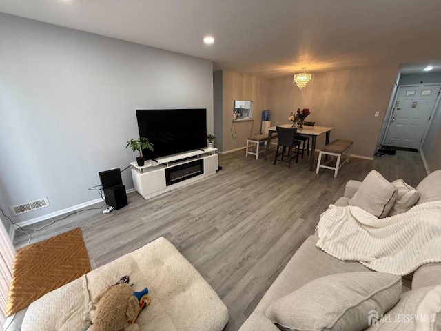 104 Morgan Pl E, Brunswick, NJ 08816 - living room featuring recessed lighting, wood finished floors, and a chandelier