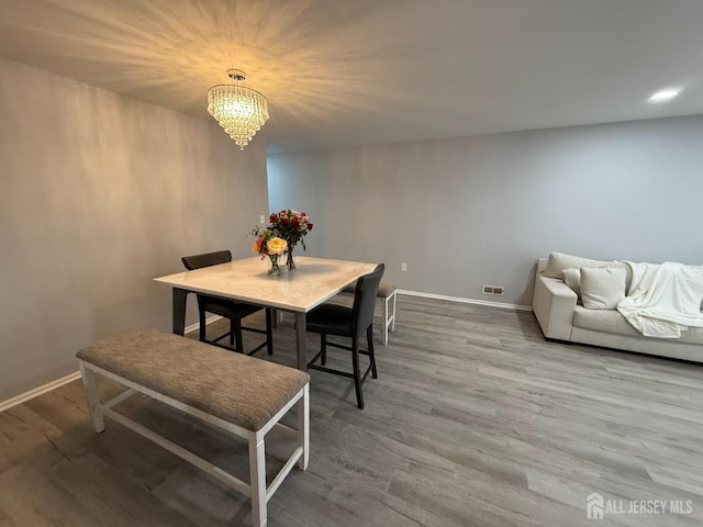 104 Morgan Pl E, Brunswick, NJ 08816 - dining room with baseboards, wood finished floors, and a chandelier