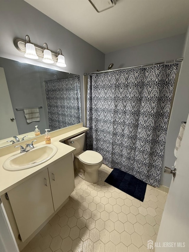 104 Morgan Pl E, Brunswick, NJ 08816 - bathroom featuring vanity, tile patterned flooring, toilet, and curtained shower