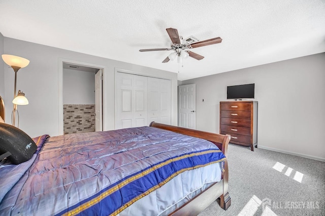 carpeted bedroom featuring a closet, a ceiling fan, and a textured ceiling