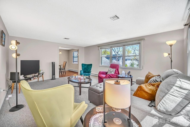 carpeted living room with a baseboard heating unit, a textured ceiling, visible vents, and baseboard heating