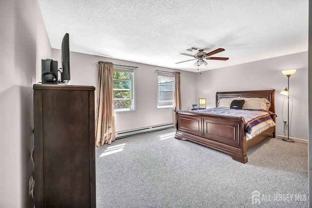 bedroom featuring a ceiling fan, a textured ceiling, baseboards, a baseboard heating unit, and carpet