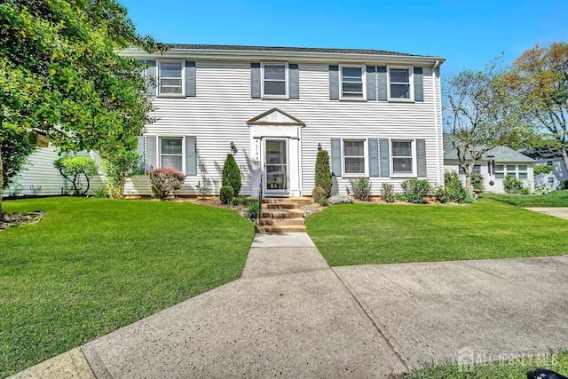 colonial-style house with a front yard