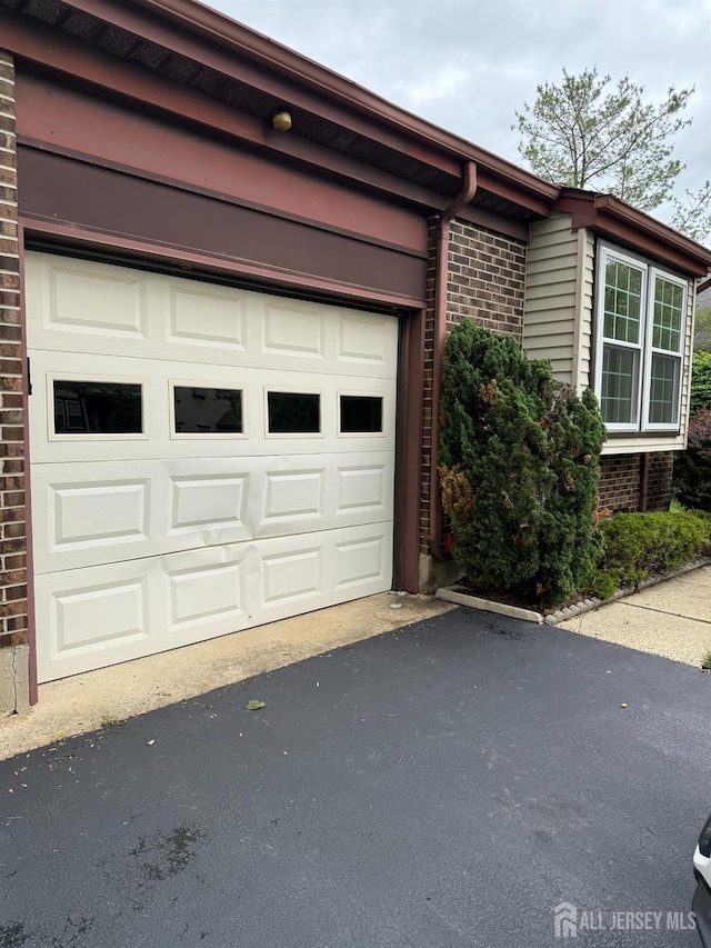 145 Concordia Cir Unit A, Monroe, NJ 08831 - view of property exterior with brick siding, asphalt driveway, and a garage