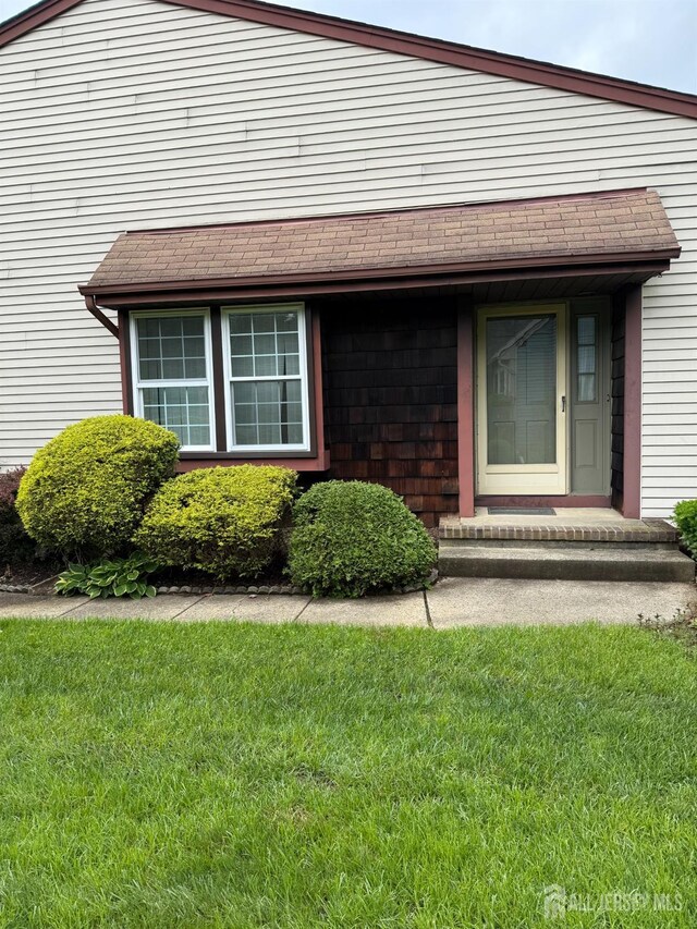 145 Concordia Cir Unit A, Monroe, NJ 08831 - doorway to property with a lawn and a shingled roof