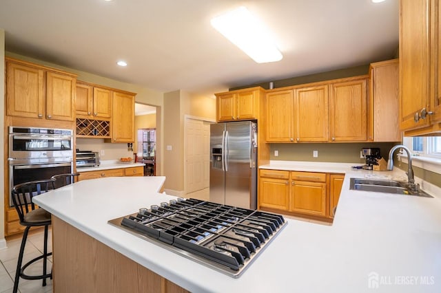 4 Cottonwood Ct, Plainsboro, NJ 08536 - kitchen with stainless steel appliances, a sink, recessed lighting, light countertops, and a breakfast bar area
