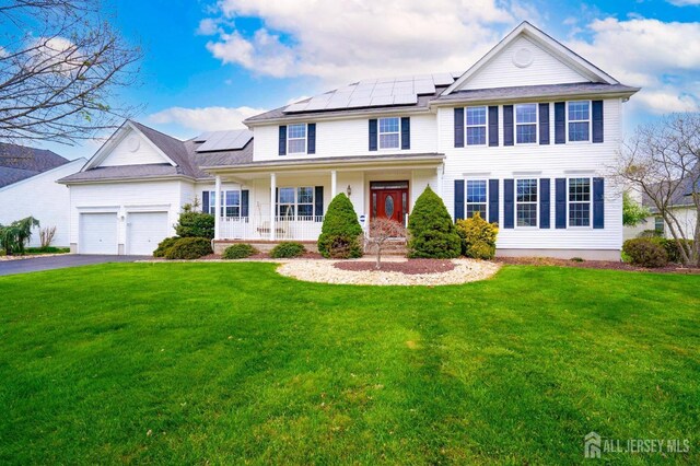 4 Cottonwood Ct, Plainsboro, NJ 08536 - view of front of home featuring a porch, a front lawn, solar panels, driveway, and a garage