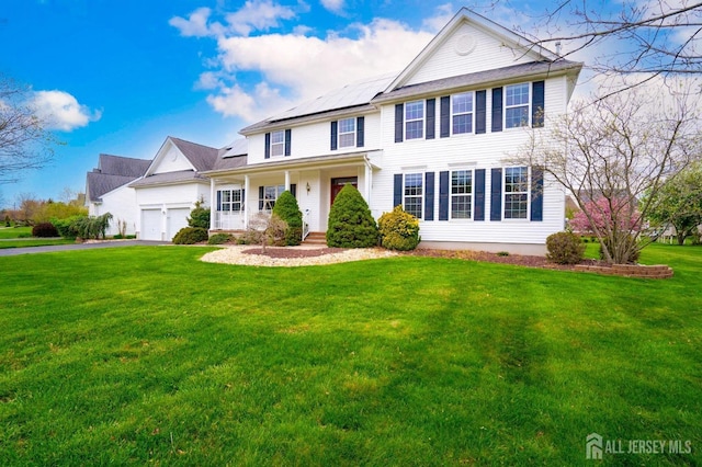 4 Cottonwood Ct, Plainsboro, NJ 08536 - view of front of home with a front lawn, roof mounted solar panels, an attached garage, and driveway