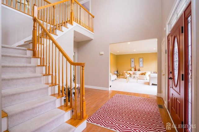 4 Cottonwood Ct, Plainsboro, NJ 08536 - foyer entrance with stairs, wood finished floors, a high ceiling, baseboards, and recessed lighting