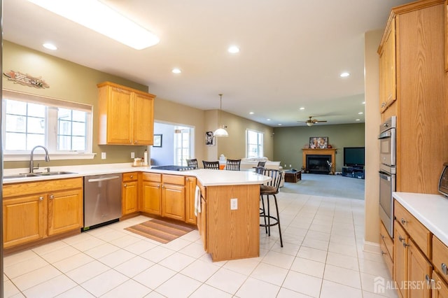 4 Cottonwood Ct, Plainsboro, NJ 08536 - kitchen featuring stainless steel appliances, a sink, a kitchen breakfast bar, a peninsula, and a ceiling fan