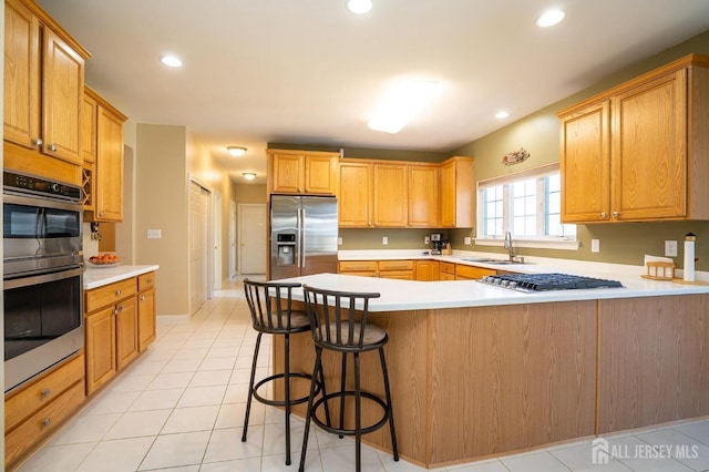 4 Cottonwood Ct, Plainsboro, NJ 08536 - kitchen featuring stainless steel appliances, a sink, a peninsula, light countertops, and recessed lighting