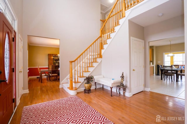 4 Cottonwood Ct, Plainsboro, NJ 08536 - foyer entrance featuring stairs, wood finished floors, a towering ceiling, baseboards, and ornamental molding