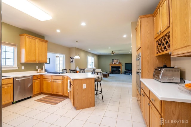 4 Cottonwood Ct, Plainsboro, NJ 08536 - kitchen with stainless steel appliances, a peninsula, a kitchen bar, open floor plan, and light countertops