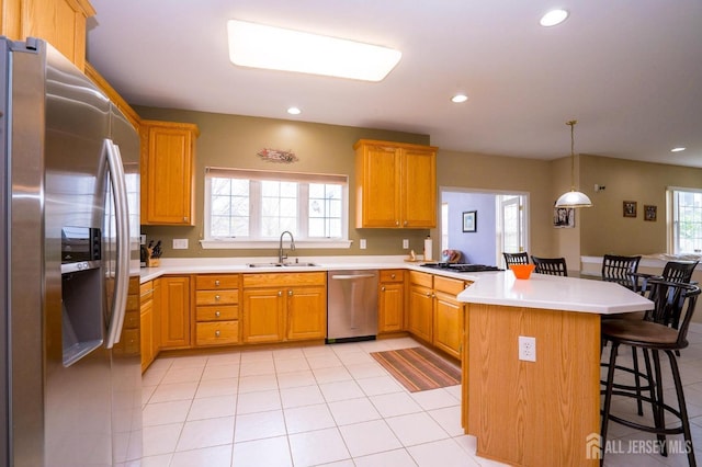4 Cottonwood Ct, Plainsboro, NJ 08536 - kitchen with appliances with stainless steel finishes, a sink, a peninsula, a breakfast bar, and light tile patterned floors