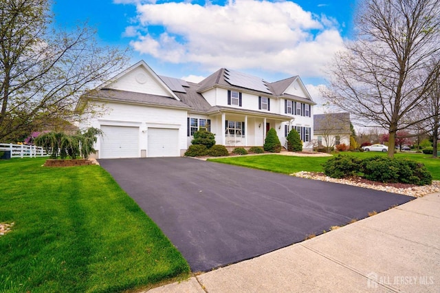 4 Cottonwood Ct, Plainsboro, NJ 08536 - view of front of house with driveway, covered porch, a garage, and roof mounted solar panels
