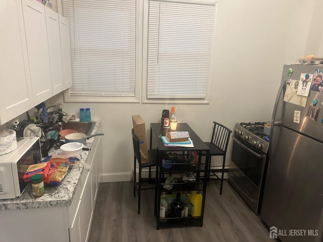 dining room with dark hardwood / wood-style flooring