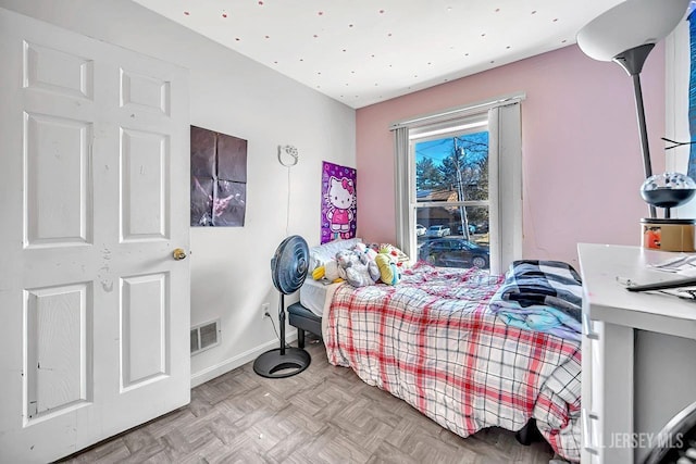 bedroom with visible vents and baseboards