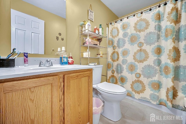 bathroom with tile patterned floors, toilet, vanity, and a shower with curtain