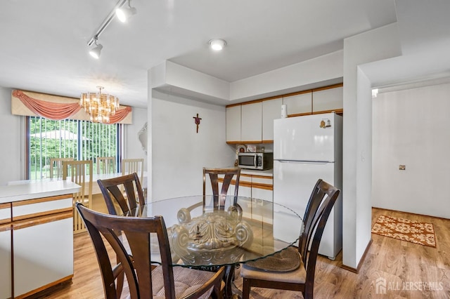 236 Community Cir, Old Bridge, NJ 08857 - dining area with light wood finished floors and a chandelier