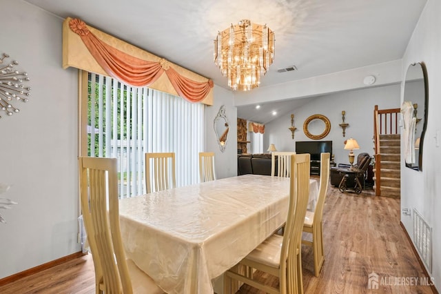 236 Community Cir, Old Bridge, NJ 08857 - dining area featuring a chandelier, wood finished floors, and stairway