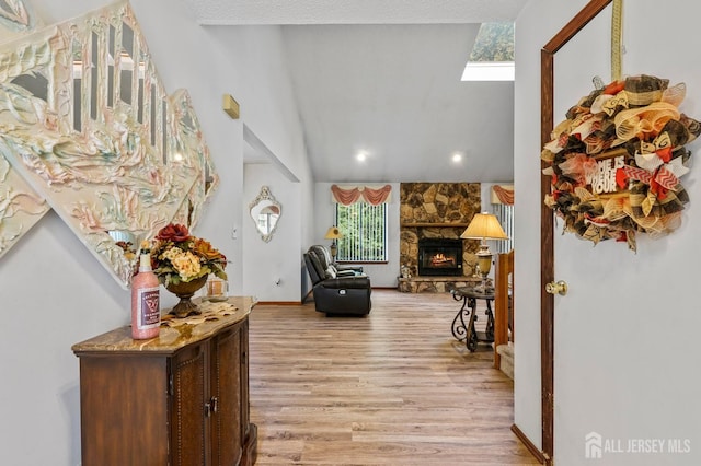 236 Community Cir, Old Bridge, NJ 08857 - foyer entrance with light wood-style flooring, a fireplace, a skylight, vaulted ceiling, and recessed lighting